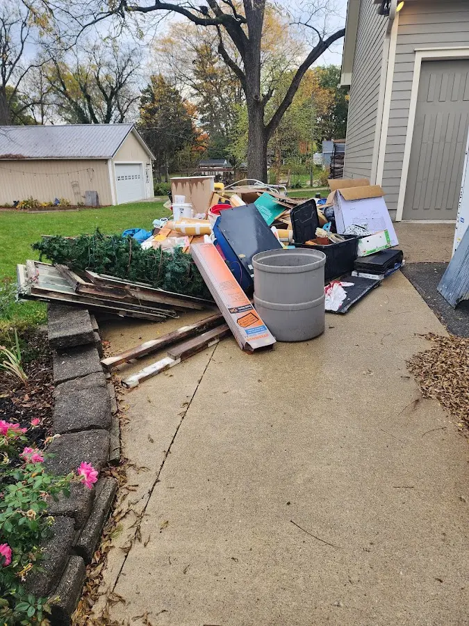 Dumpster being loaded with debris for 12 Yard Dumpster Rental in Gorham